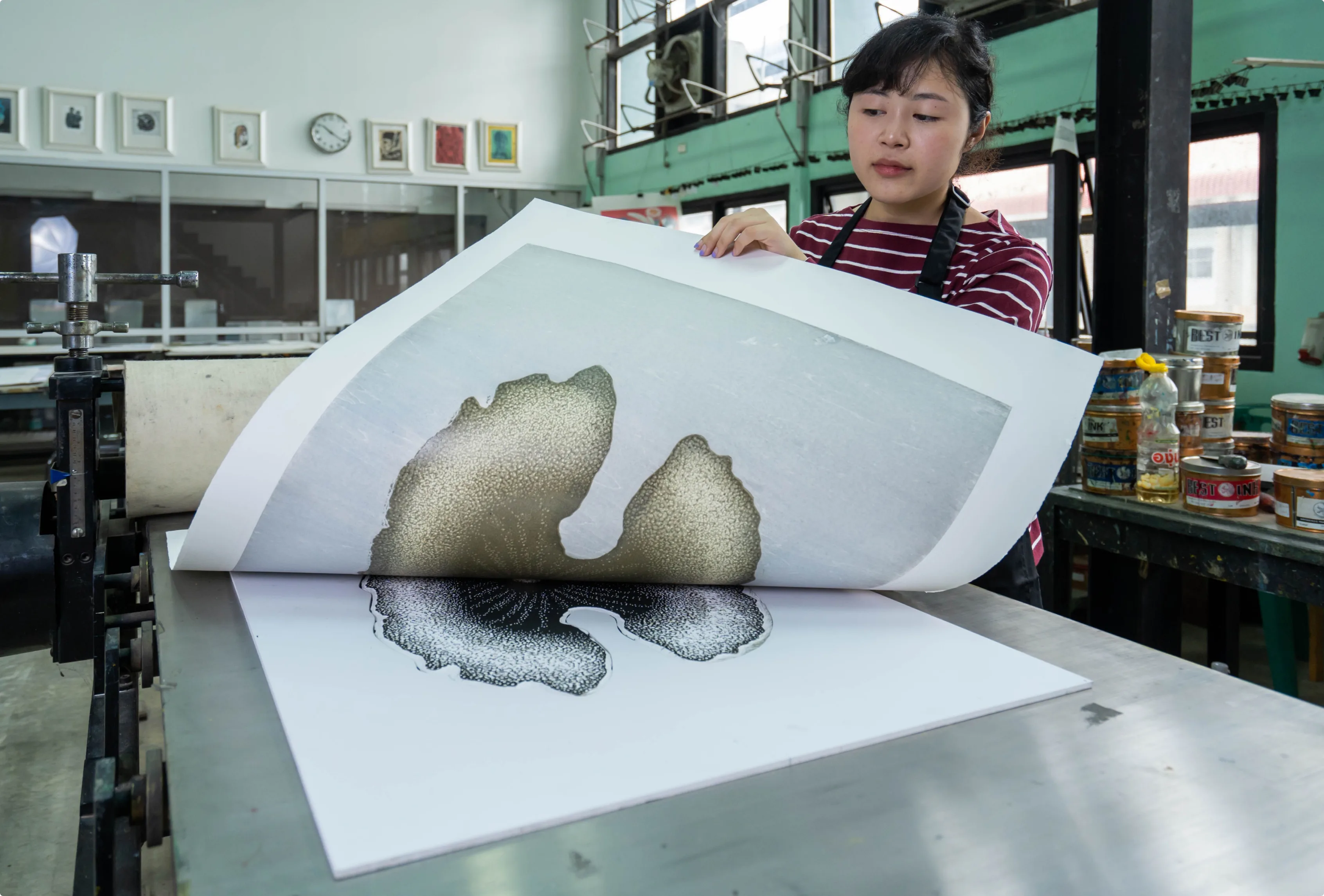 Artist revealing a print in a studio workshop