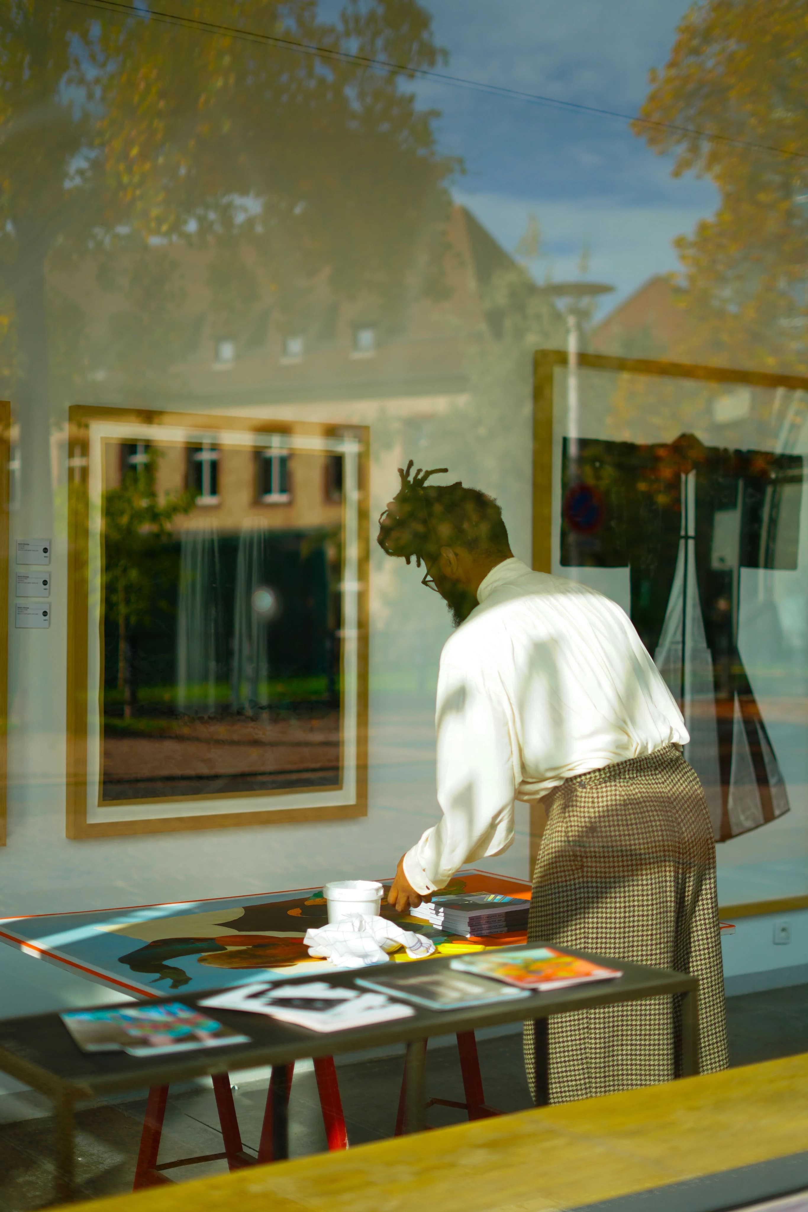 Gallery interior with art professional at work